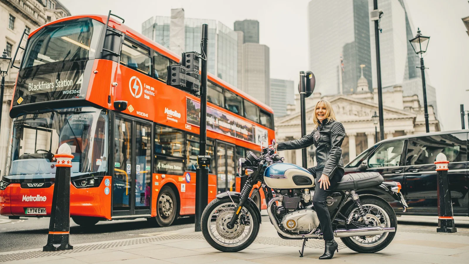 The Lady Mayor Dame Susan Langley with a Triumph motorcycle.